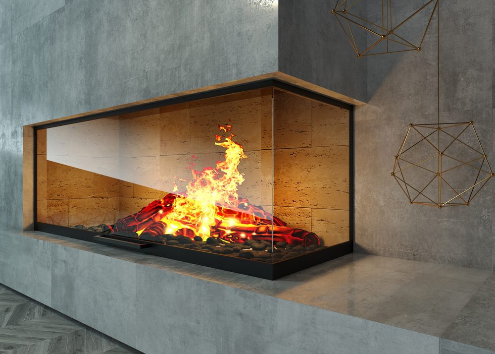A Modern Glass Fireplace That's Built Into The Corner Of A Wall.