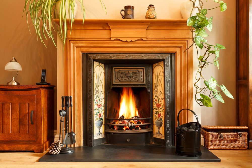 Close up fireplace, traditional Victorian style open fire place burning coal in a living room