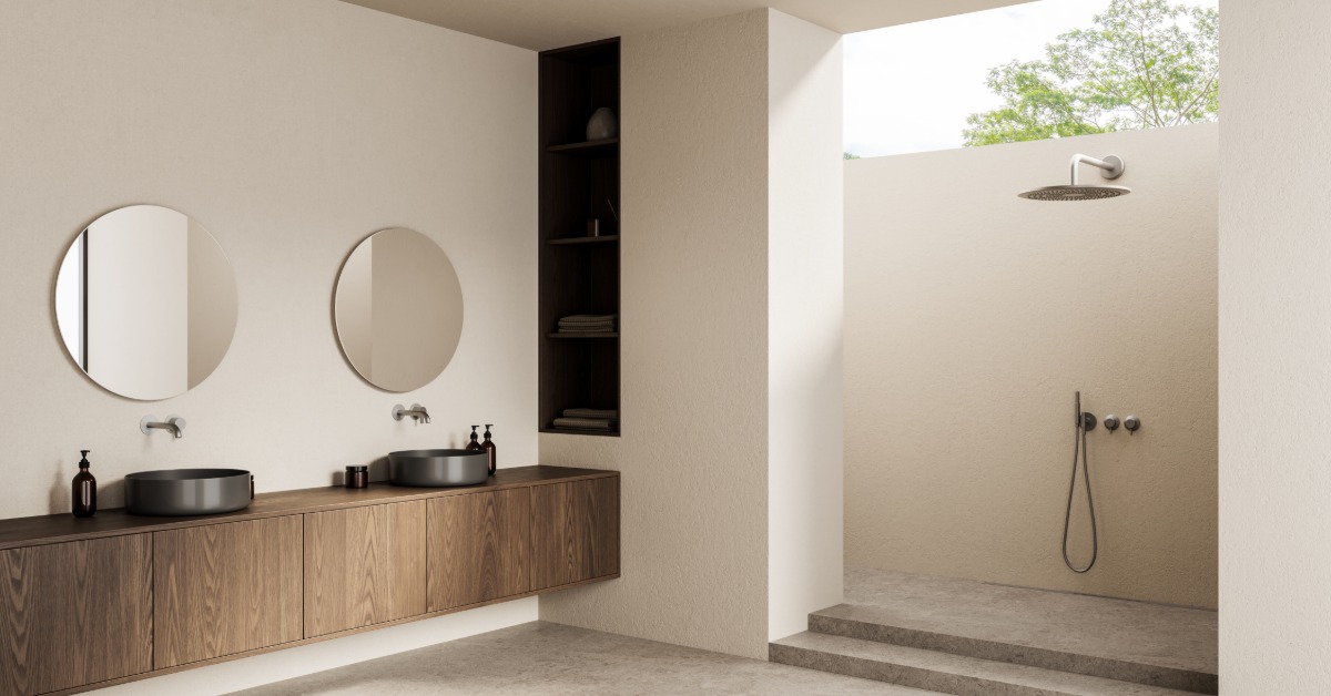 A modern bathroom with a floating wooden counter, double sinks and mirrors with an open shower on the side.