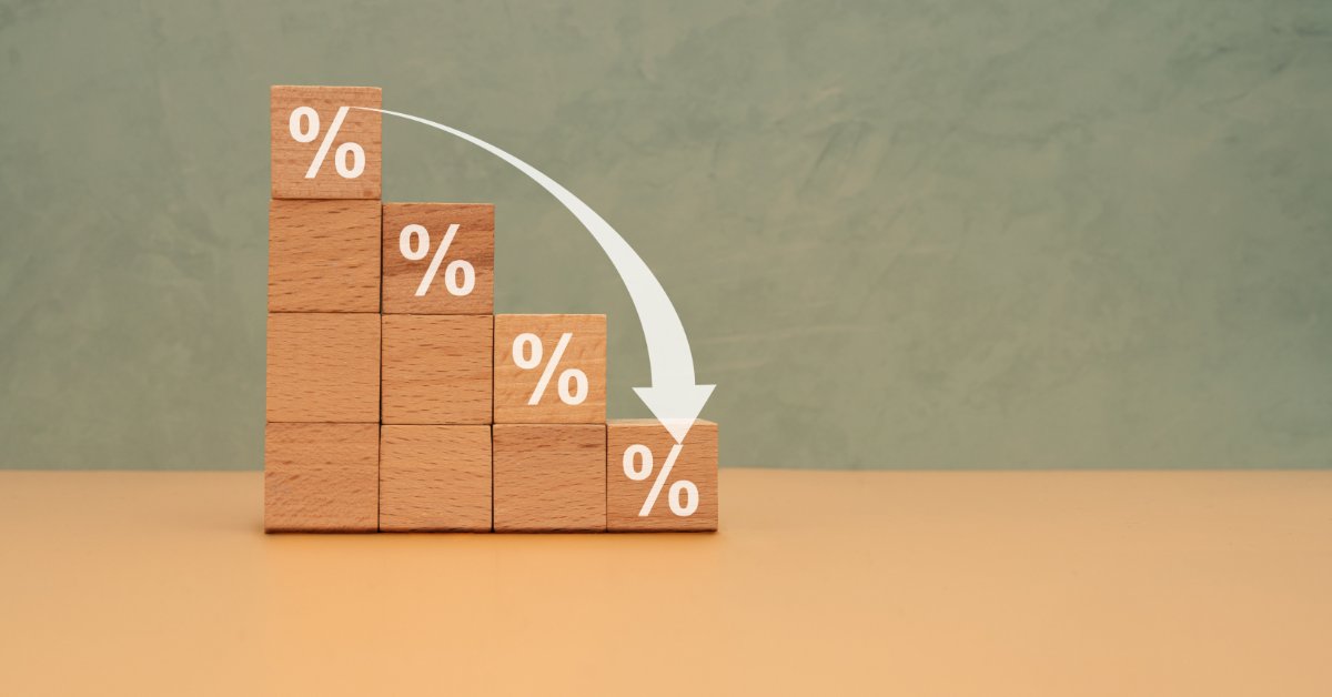A stack of wooden cubes in piles of different sizes, displaying a percentage symbol at the top with an arrow going down.